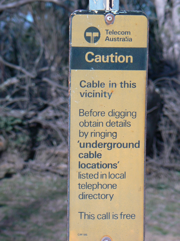 A bit further up the mountain is a sign warning of underground cabling in the vicinity. The sign was erected by Telecom Australia before they changed their name to Telstra, and has clear signs of fading from being exposed to the elements.