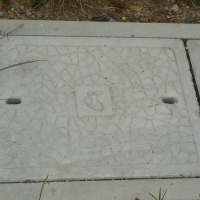 A Telstra pit cover.